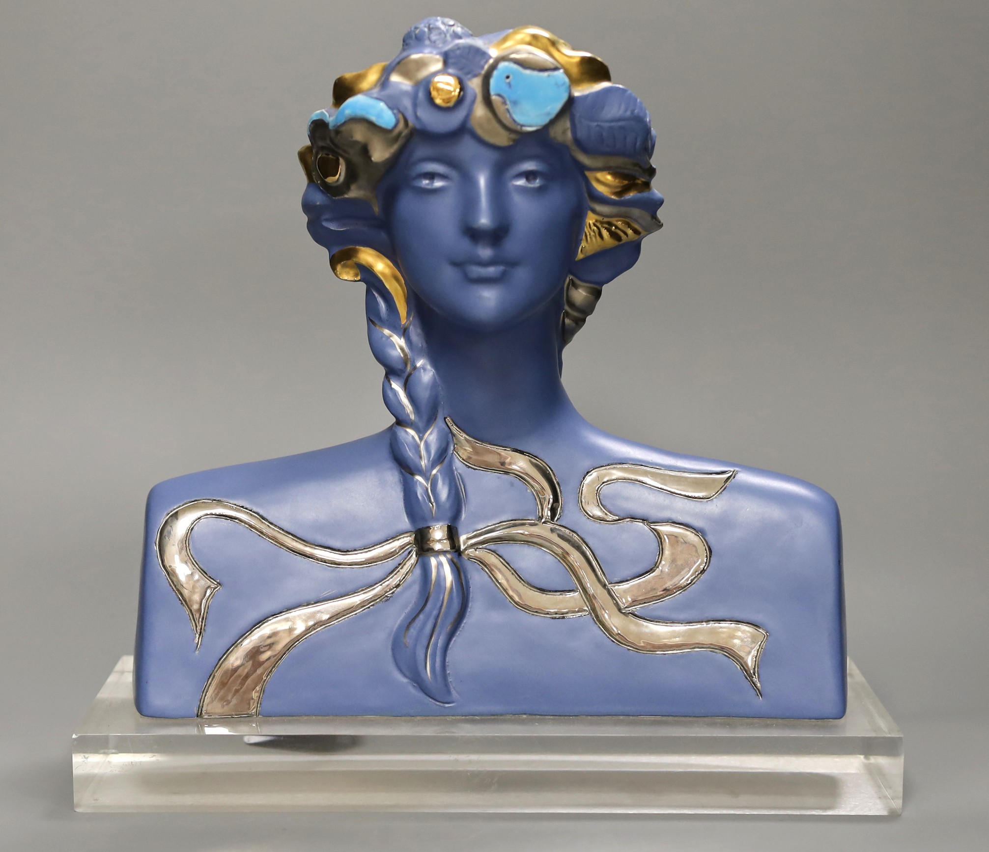 A limited edition blue glazed ceramic bust, signed A.Carreno, 197/500, 29cm tall